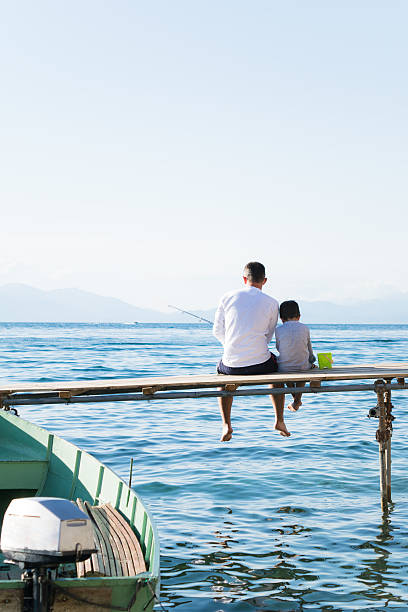 istock Father and son fishing 540849564