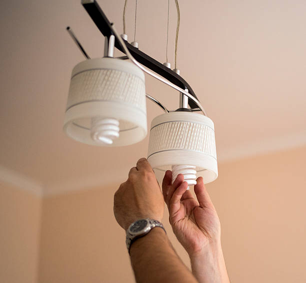 Man installing  bulb stock photo