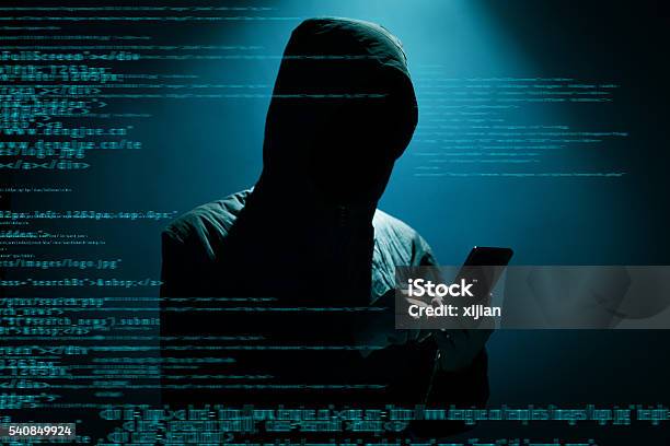 Hacker Using Phone Stock Photo - Download Image Now - Computer Hacker, Surveillance, Computer Crime