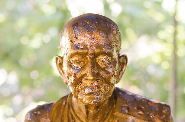 Closeup of golden buddha. Focus on eye.