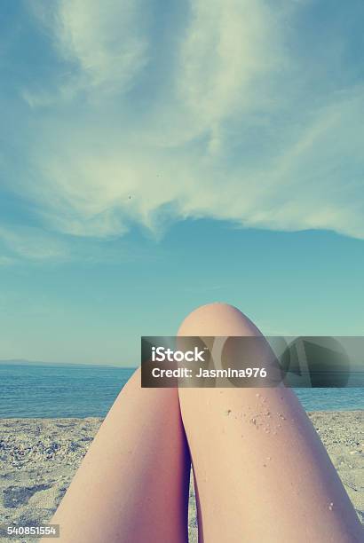 Knees Of Young Woman On The Beach Personal Pov Retro Stock Photo - Download Image Now