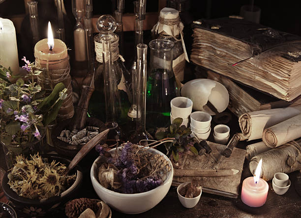 Still life with witch books, scrolls, herbs and magic objects stock photo