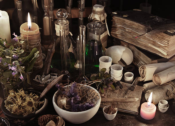 still life with witch books, scrolls, herbs and magic objects - alchemist imagens e fotografias de stock