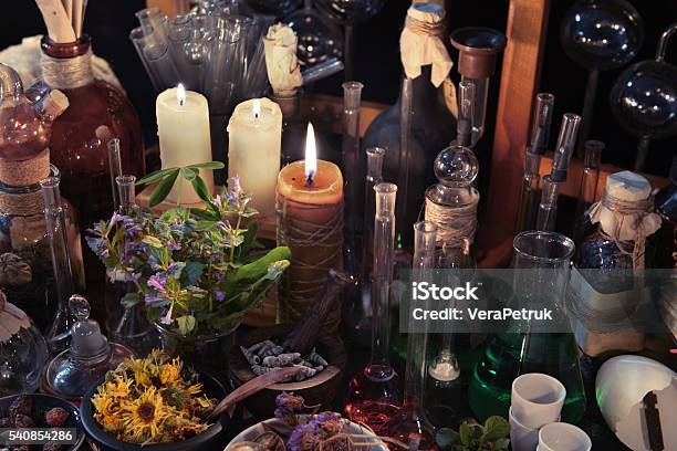 Homeopathic Still Life With Bottles Flasks Old Candle And Herbs Stock Photo - Download Image Now