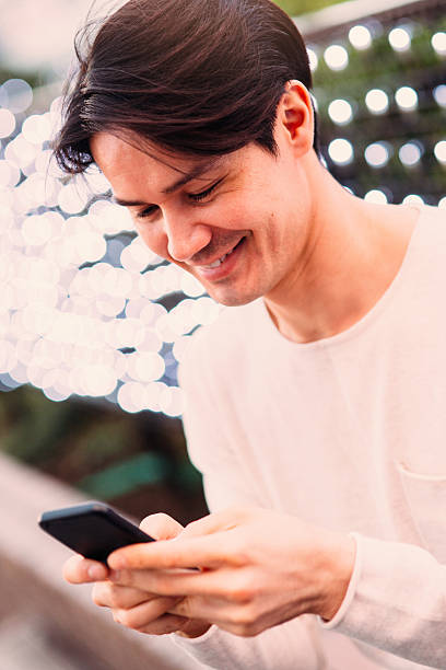 istock Young japanese man texting on the phone 540854960