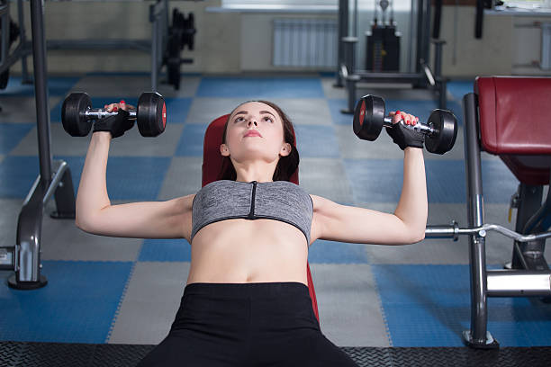 istock Young happy woman training in the gym 540855672