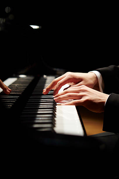 Man playing the grand piano stock photo