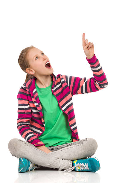istock Excited Child Girl Looking Up And Pointing 540858460