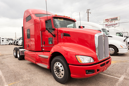 Dallas, Tx, USA - April 9, 2016: New Kenworth T680 high-roof sleeper semitrailer truck at the dealership. 