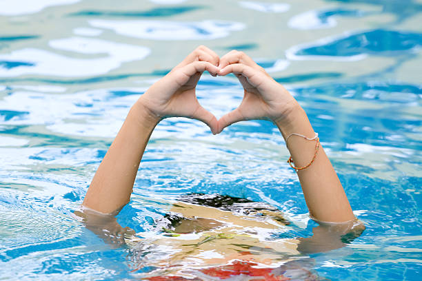 istock heart shape made of beautiful hand come up from water 540862104