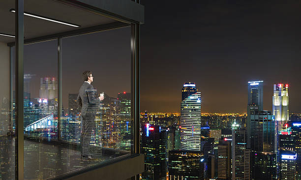 istock Businessman on balcony at night 540862642