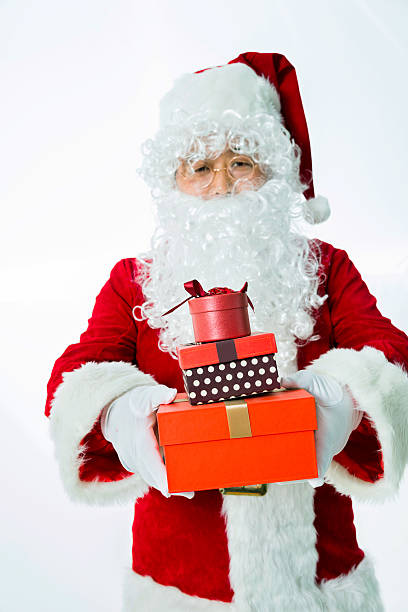 santa claus holding sack of presents isolated on white background.
