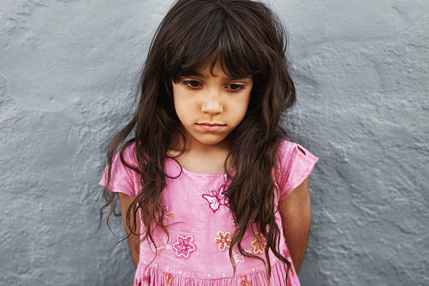 istock Little girl standing looking upset 540864444