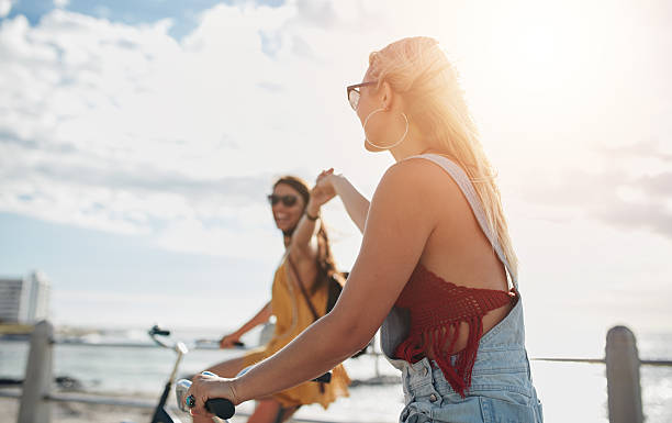istock Young women enjoying riding bicycles on a summer day 540864668