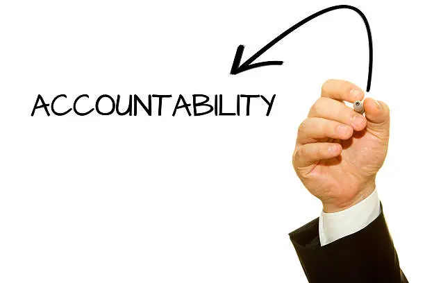 Photo of Businessman hand writing Accountability with a marker.