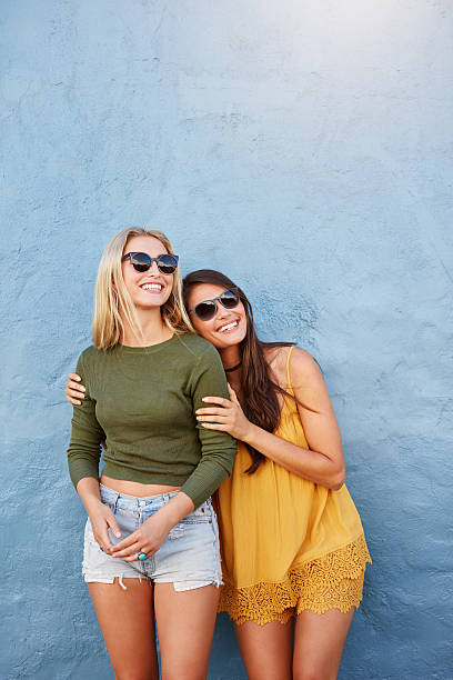 istock Stylish female models looking away and smiling 540865400