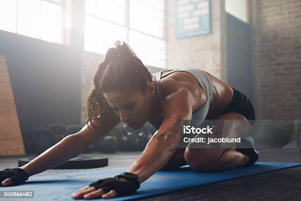 Young Woman Doing Yoga On The Gym Floor Stock Photo - Download Image Now - Adult, Adults Only, Back