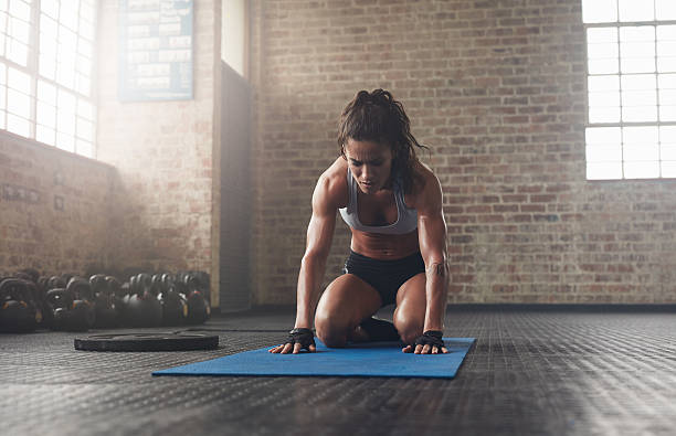 istock Young woman doing a forward bend exercise on fitness mat 540866554