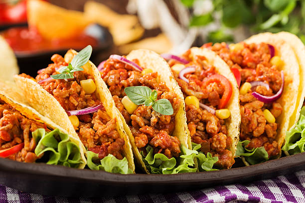 istock Tacos with meat and vegetables on wooden board 540867782