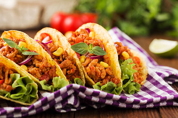 istock Tacos with meat and vegetables on wooden board 540867924