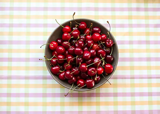 A lot of cherries. Cherries in a bowl on the table. Crop, orchard, berries. Healthy nutrition. Ripe berries. In the kitchen. Diet. Cherry plate. Still life food.