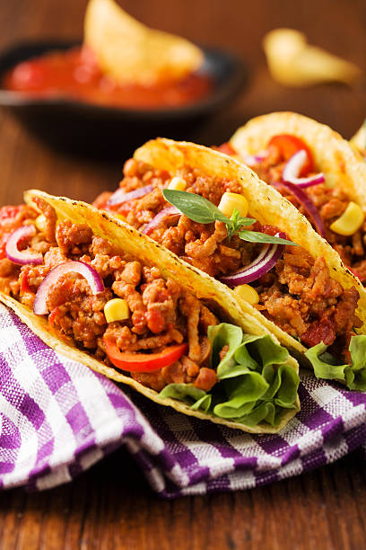 istock Tacos with meat and vegetables on wooden board 540867988