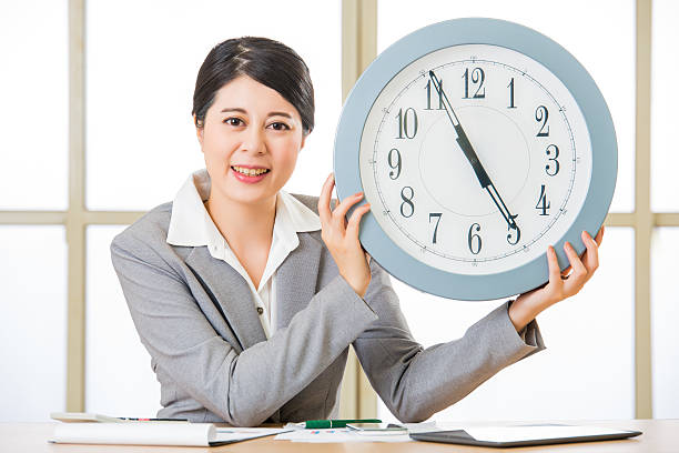 istock Happy asian business woman showing clock 540868408