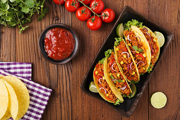 istock Tacos with meat and vegetables on wooden board 540868534