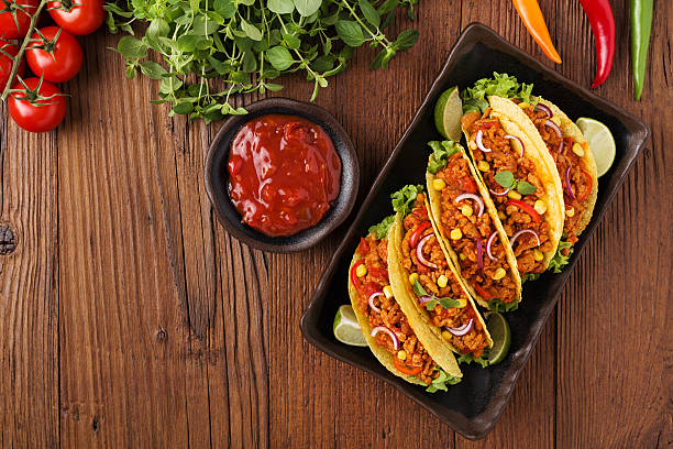 istock Tacos with meat and vegetables on wooden board 540868650