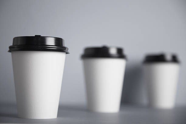istock White paper cups isolated on gray mockup set 540870084