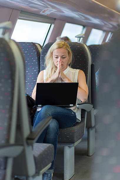 istock Woman travelling by train working on laptop. 540870306