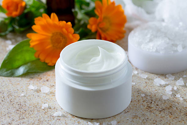istock Face Cream marigold on brown stone background - beauty salon. 540871134