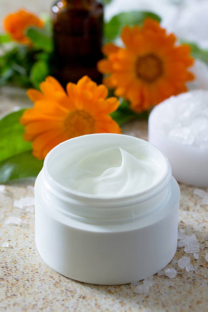 istock Face Cream marigold on brown stone background - beauty salon. 540871198