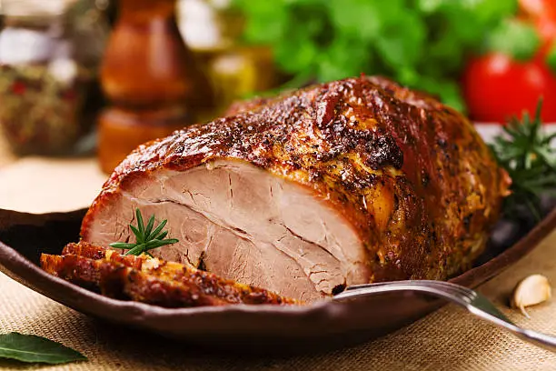 Roast pork with herbs and vegetables.