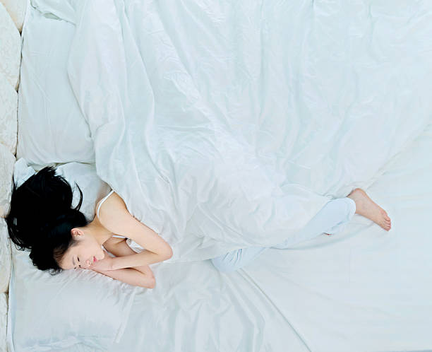 A smiling man resting in his comfortable bed