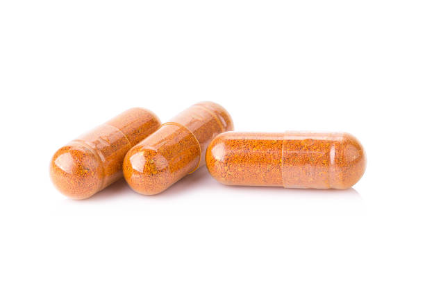 istock Turmeric powder inside a capsule isolated on white 540960978