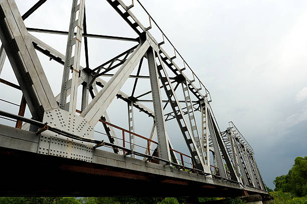 istock Railway bridge, railway abuts the stormy sky, bottom view. 540960994