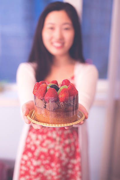 istock Woman holding a cake 540961028