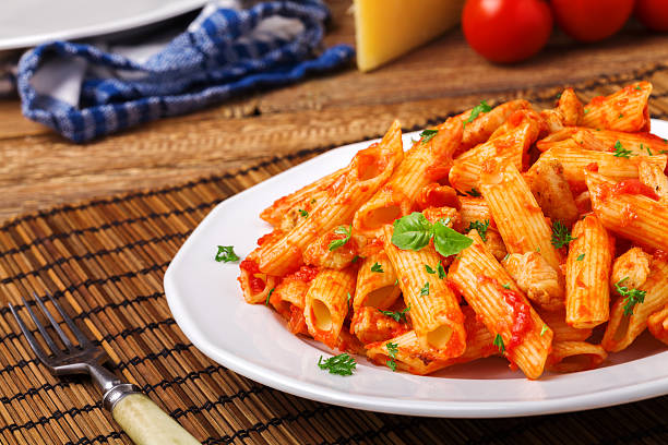 istock Penne with roasted chicken in tomato sauce 540962372