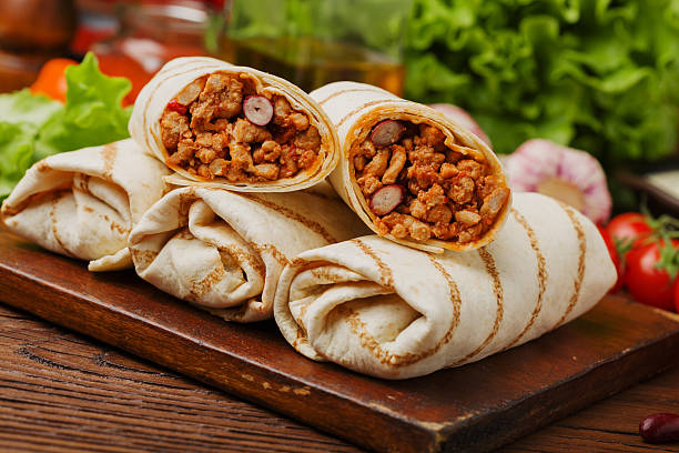 istock Burritos wraps with meat, beans and vegetables. 540964554