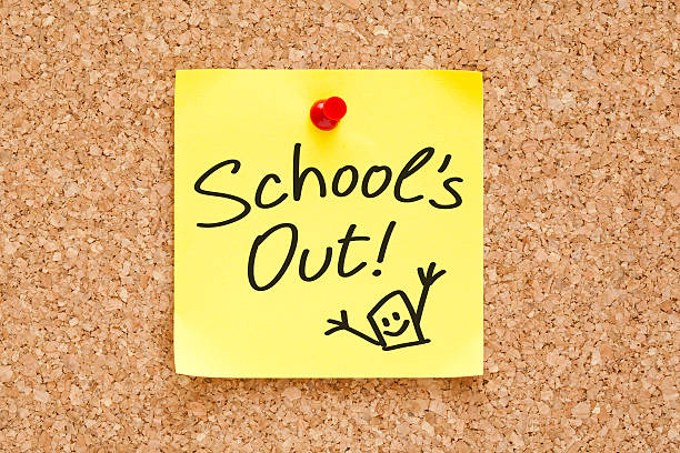 School Is Out Sticky Note School is Out handwritten on a sticky note pinned on cork bulletin board. weekend activities stock pictures, royalty-free photos & images
