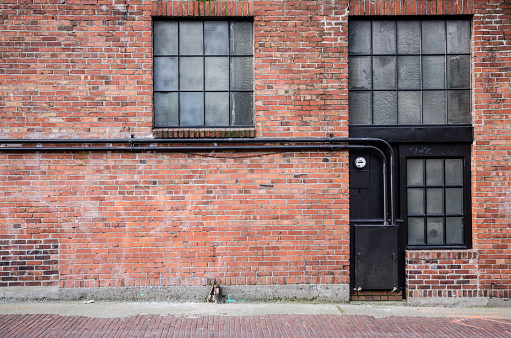 Old brick alleyway with windows.