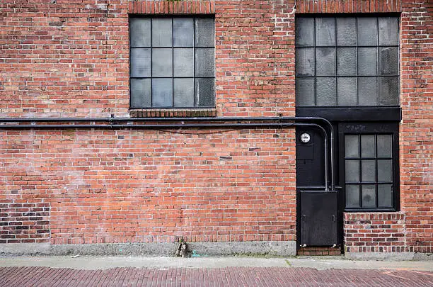 Old brick alleyway with windows.