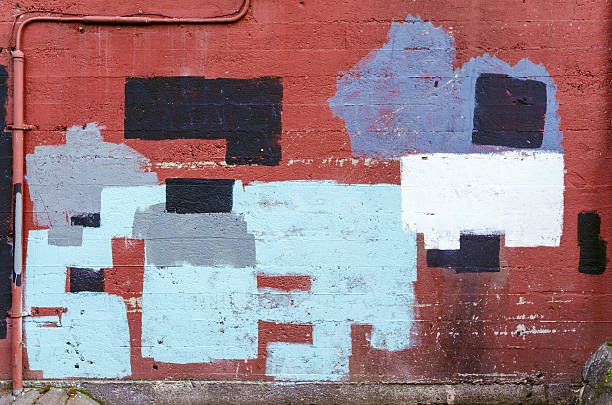 istock Brick wall in alleyway with random spots of paint 540968474