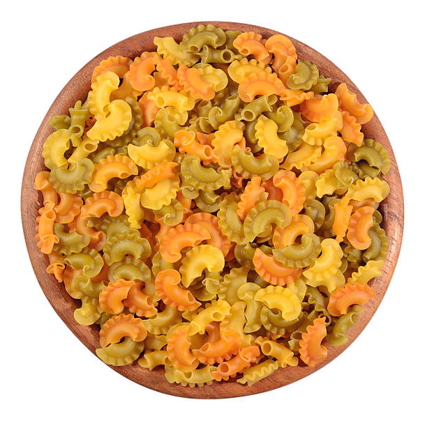 istock Colored uncooked italian pasta in a wooden bowl 540968854