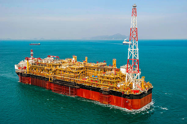 Oil & Gas offshore FPSO Oil Rig View of FPSO oil rig, floating production, storage and offloading vessel used to explore the crude oil & gas under the seabed. floating oil production platform stock pictures, royalty-free photos & images