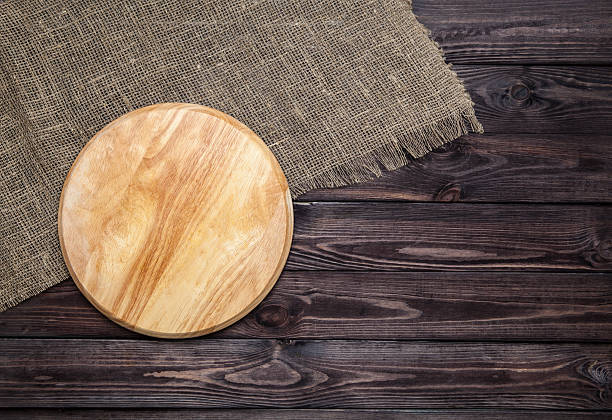 istock Cutting board on wooden table, top view 540969256