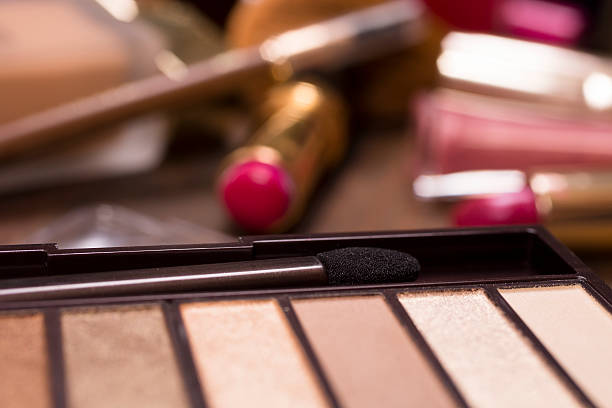 istock Pile of various cosmetics, make-up lie on wooden dressing table. 540969810