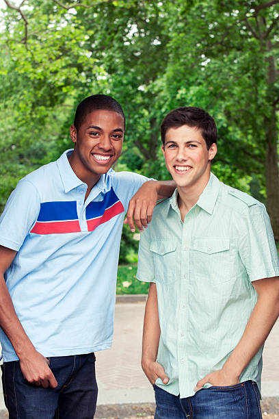 Portrait of two teenage boys hanging out at the park