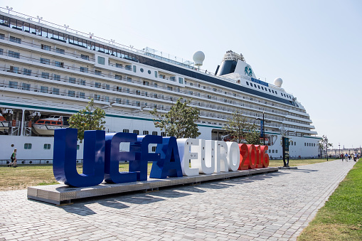 Bordeaux, France - July 16, 2015: The magnificent Crystal Serenity cruise ship is docked on the river Gironde in the heart of Bordeaux behind the large colorful sign advertising the famous UEFA EURO 2016 football tournament.